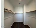 Spacious walk-in closet with shelving and ample storage space for clothing and accessories at 7418 W Rovey Ave, Glendale, AZ 85303