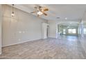 Open living room showcasing wood-look tile, neutral walls, and an airy ceiling at 7642 W Carlota Ln, Peoria, AZ 85383