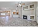 Spacious living room with a fireplace, open floor plan, and a breakfast bar at 7642 W Carlota Ln, Peoria, AZ 85383