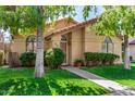 Attractive single-story home boasting a red tile roof, rounded windows, and verdant front lawn at 855 E Vaughn Ave, Gilbert, AZ 85234