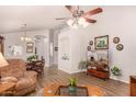 Bright living space with wood-look floors, ceiling fan and views of the dining area at 855 E Vaughn Ave, Gilbert, AZ 85234