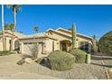 Beautiful home with a desert-themed yard featuring a variety of native plants and a tiled roof at 8632 E Gail Rd, Scottsdale, AZ 85260