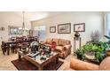 Inviting living room with a comfortable leather couch, a dark wood dining table, and plenty of natural light at 8632 E Gail Rd, Scottsdale, AZ 85260