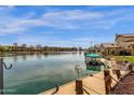 View of a backyard waterfront dock and relaxing lake view from the backyard at 9019 W Acoma Dr, Peoria, AZ 85381