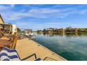 View of a backyard waterfront dock and relaxing lake view from the backyard at 9019 W Acoma Dr, Peoria, AZ 85381