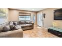 Cozy living room with tile floors and a comfortable sectional sofa at 9031 N 14Th St, Phoenix, AZ 85020