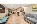 Open-concept living room with tile floors and a bar area leading to the kitchen at 9031 N 14Th St, Phoenix, AZ 85020