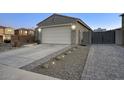 A home exterior features desert landscaping, a two car garage, and paved driveway at 9543 W Donald Dr, Peoria, AZ 85383