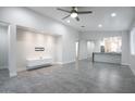 This living room features tile floors, recessed lighting, and open access to the kitchen at 9543 W Donald Dr, Peoria, AZ 85383