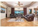 Spacious living room featuring leather sofas, decorative ceiling, and scenic views at 10142 E La Palma Ave, Gold Canyon, AZ 85118