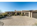 Charming home with a large driveway and a three car garage at 10238 E Rising Sun Dr, Scottsdale, AZ 85262