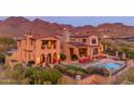 Beautiful backyard featuring a pool, lounge chairs, mountain views, and lush landscaping at 10935 E Grandview Way, Scottsdale, AZ 85255