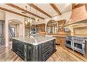 Spacious kitchen featuring a large center island, stainless steel appliances, and wood beam ceilings at 10935 E Grandview Way, Scottsdale, AZ 85255