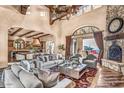Open concept living room with stone fireplace, high ceilings, and seamless indoor/outdoor living at 10935 E Grandview Way, Scottsdale, AZ 85255