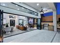 Stunning indoor/outdoor living space with a large folding glass door, custom built-ins, and tiled floors at 11578 N 80Th Pl, Scottsdale, AZ 85260