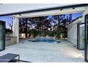 A luxurious outdoor space features a modern pool with integrated waterfall and an outdoor kitchen, creating an ideal entertainment space at 11578 N 80Th Pl, Scottsdale, AZ 85260