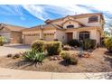 Charming two-story home with a three-car garage and a desert-landscaped front yard at 1213 W Deoni Trl, San Tan Valley, AZ 85143