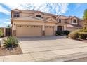 Charming two-story home boasts a spacious three-car garage and well-maintained front yard at 1213 W Deoni Trl, San Tan Valley, AZ 85143