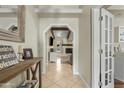 Welcoming foyer features wood look flooring, light walls, and an arched entryway with wooden beam at 1331 E Bates St, Mesa, AZ 85203