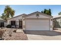 Charming single-story home featuring a well-maintained yard, two-car garage, and desert landscaping at 1345 W Diamond Ave, Apache Junction, AZ 85120
