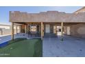 Exterior of home with seating area, putting green and rustic columns at 1373 E 23Rd Ave, Apache Junction, AZ 85119