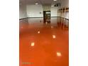 Spacious garage with vibrant, stained concrete floors and convenient shelving at 1373 E 23Rd Ave, Apache Junction, AZ 85119