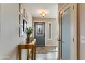 Bright entryway featuring a decorative front door, table and wood look floors at 15056 N 43Rd St, Phoenix, AZ 85032