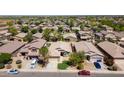 Expansive aerial view showcasing a residential neighborhood with uniform houses and well-kept landscaping at 16188 W Hearn Rd, Surprise, AZ 85379