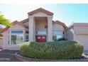 Attractive single-Gathering home showcasing a grand entrance with red doors and desert landscaping at 1915 E Citation Ln, Tempe, AZ 85284
