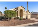 Charming single-story home with arched entryway, desert landscaping, and attached two car garage at 19185 N 116Th Ln, Surprise, AZ 85378