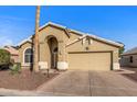 Charming single-story home with arched entryway, desert landscaping, and attached two car garage at 19185 N 116Th Ln, Surprise, AZ 85378