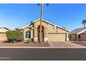 Charming single-story home with arched entryway, desert landscaping, and attached two car garage at 19185 N 116Th Ln, Surprise, AZ 85378