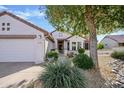 Inviting single-story home with a two-car garage, charming curb appeal, and mature landscaping at 20113 N Lagos Ct, Surprise, AZ 85374