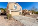 Charming home with a two-car garage, desert landscaping, and a well-maintained front yard at 21876 W Mohave St, Buckeye, AZ 85326