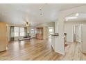 Open-concept living room featuring vaulted ceilings, wood floors, and natural light at 2263 N Trekell Rd # 175, Casa Grande, AZ 85122