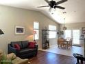 Open-concept living room with a ceiling fan, sofa, and dining area visible in background at 2416 N Snead Dr, Mesa, AZ 85215