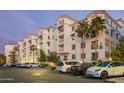 Exterior building view featuring parking spaces and palm trees with beautiful architecture at 2511 W Queen Creek Rd # 307, Chandler, AZ 85248
