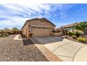 Desert landscaping with gravel and stone pavers accenting the exterior facade and driveway at 26057 W Sequoia Dr, Buckeye, AZ 85396