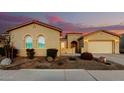 Charming home featuring stucco siding, a tile roof, and desert landscaping during a beautiful sunset at 26199 S 227Th St, Queen Creek, AZ 85142