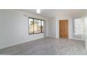 Bright living room with a large window and wood-style flooring, perfect for relaxing and entertaining at 2907 S Elm St, Tempe, AZ 85282