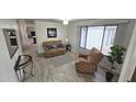 Cozy living room with neutral colors, comfortable seating, large window with blinds and wood-look flooring at 2907 S Elm St, Tempe, AZ 85282