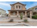 Charming two-story home with covered porch and desert landscaping adds curb appeal and a touch of southwest character at 34913 N 30Th Dr, Phoenix, AZ 85086