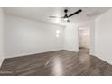 Spacious bedroom with wood floors, ceiling fan, neutral colors, and ensuite bathroom at 3555 E Erie St, Gilbert, AZ 85295