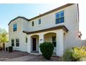 Charming home featuring a covered entrance with arches, complemented by desert landscaping and a paver walkway at 3555 E Erie St, Gilbert, AZ 85295