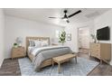 Bright main bedroom with sleek ceiling fan, stylish wood furniture, and plenty of natural light at 3555 E Erie St, Gilbert, AZ 85295