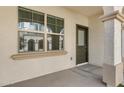 Covered front porch with large window and dark green front door at 4020 E Toledo St # 103, Gilbert, AZ 85295