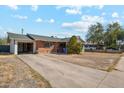 Cozy single-story brick home with an attached garage, a concrete driveway and a well-maintained front yard at 4020 W Tuckey Ln, Phoenix, AZ 85019