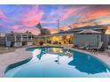 Sparkling pool with a covered gazebo, complemented by a lounge area and an umbrella for shade and relaxation at 4245 N 16Th Dr, Phoenix, AZ 85015