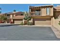 Beautiful townhome featuring a private patio, two-car garage, and stucco exterior at 4434 E Camelback Rd # 132, Phoenix, AZ 85018