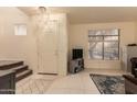 Bright entryway with tile floors, staircase, and a view of a window with natural light at 7304 E Northridge Cir, Mesa, AZ 85207